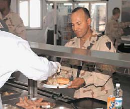 [Soldier being served food in cafeteria]
