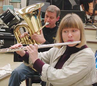 man playing tuba, woman playing flute